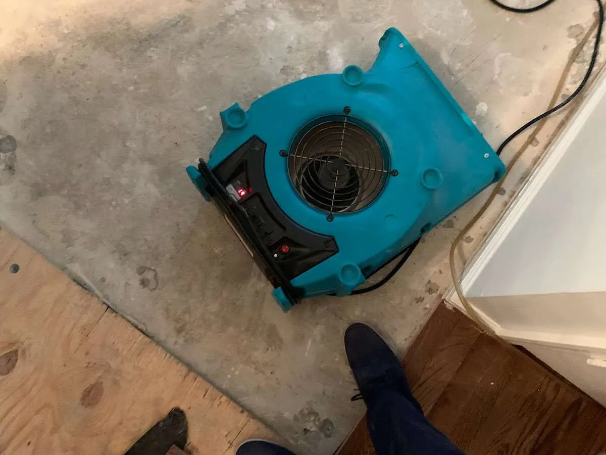 Air mover drying subfloor during Commercial Water Damage Restoration in Plainfield
